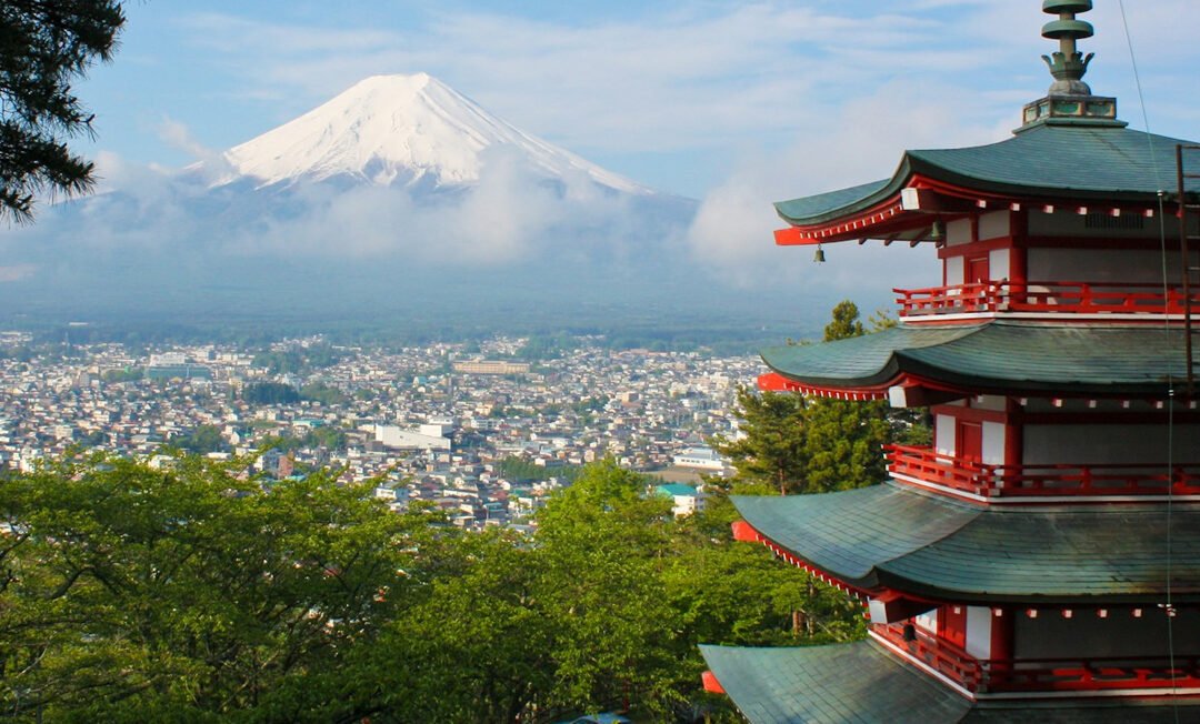A dynamic cityscape of Tokyo, showing a blend of traditional Japanese architecture juxtaposed with modern skyscrapers and an efficient transportation system Cherry blossoms could be subtly integrated into the foreground.