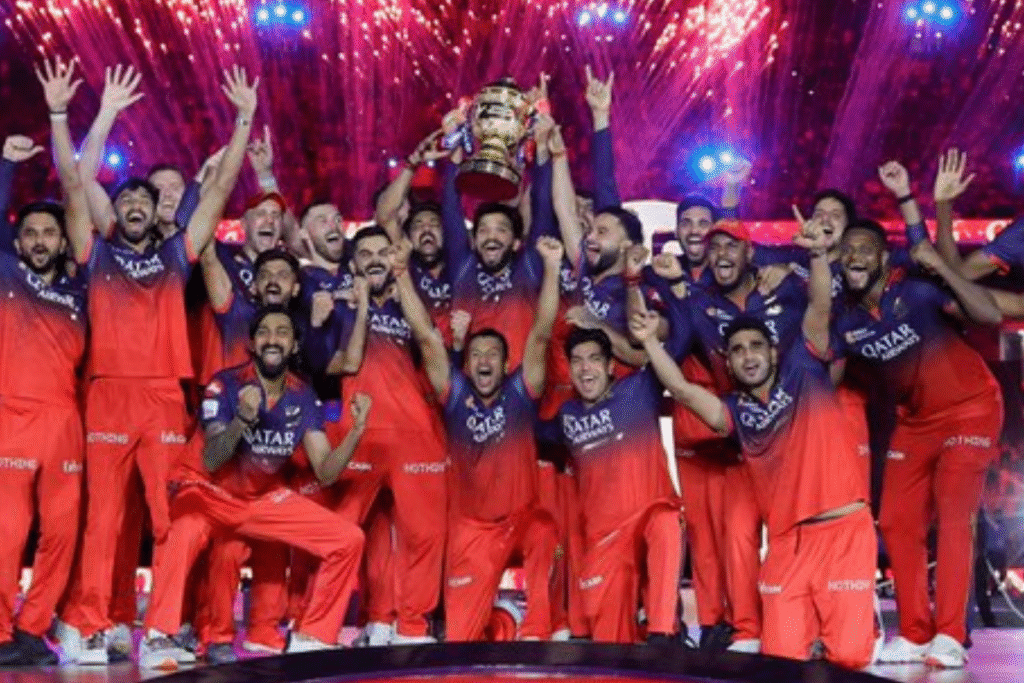 RCB IPL 2025 Champions: Virat Kohli, Rajat Patidar, and team celebrate with the trophy, a historic moment of victory.