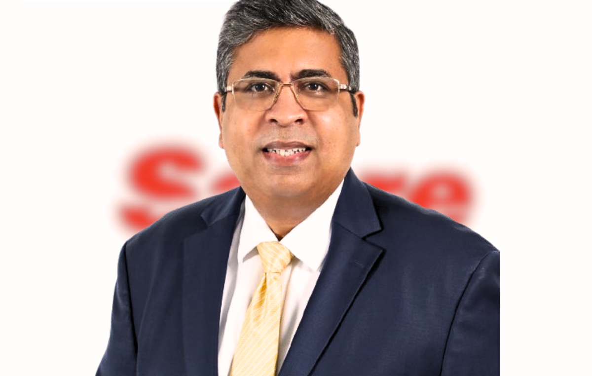 Professional headshot of Maneesh Jaikrishna, smiling confidently.