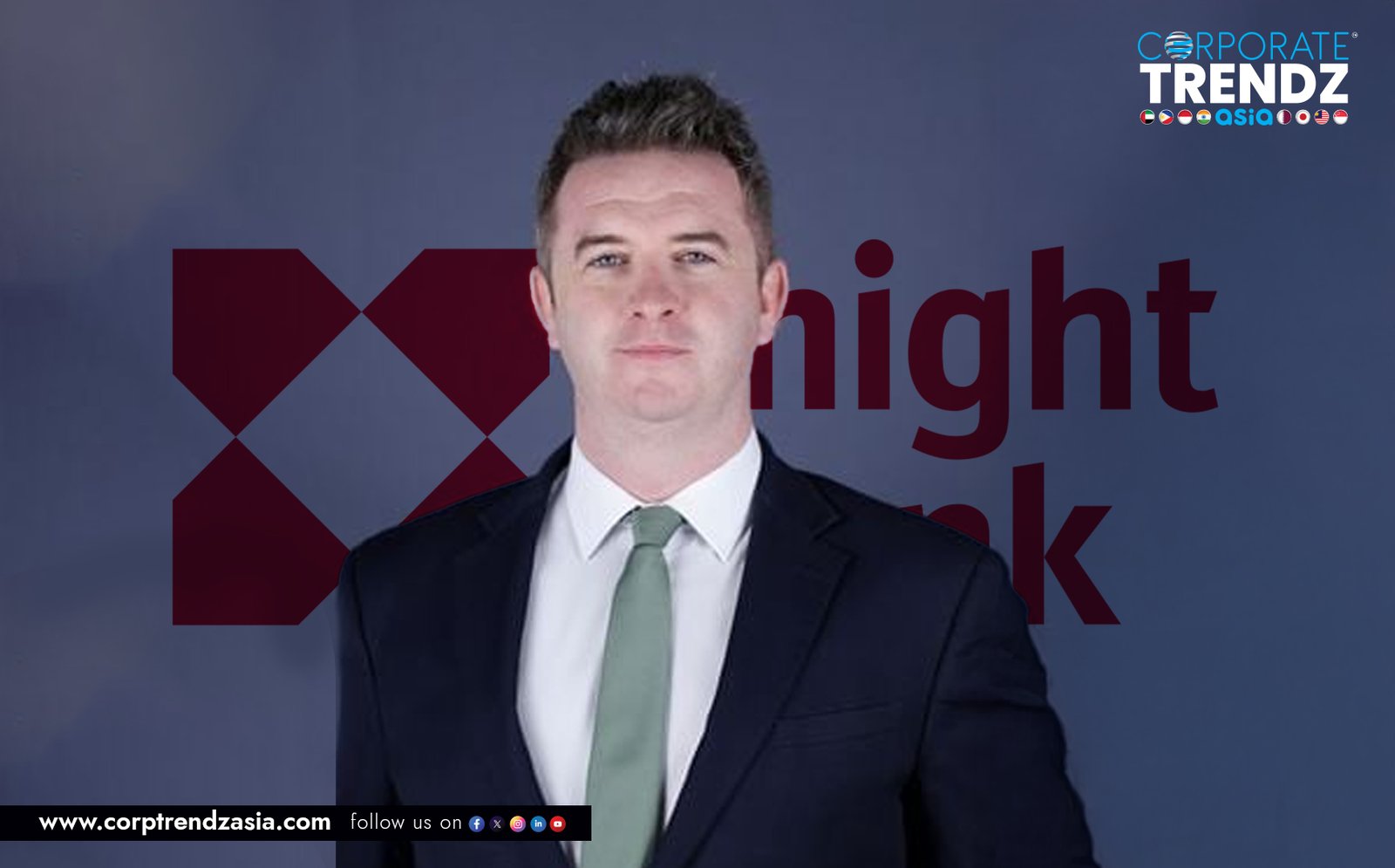 A professional headshot of James Wrenn, a man with a friendly smile, against a light-colored, out-of-focus background.