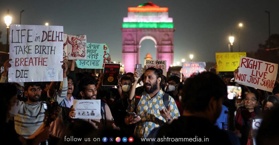 A powerful image of protestors at India Gate, with some holding "Let us breathe" signs, as mothers show nebulisers to highlight the public health crisis in Delhi.